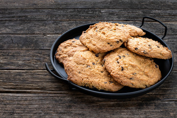 Fresh homemade chocolate chip cookies preparation on rustic table
