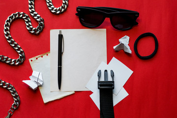 photo for mock up composition with paper and different black objects top view red background fashion
