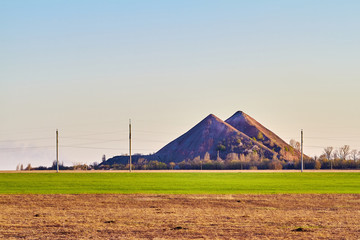 Ukrainian slagheap on a skyline. Spring, field, grass.