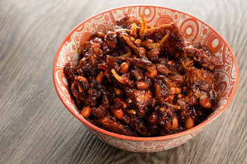 friend tempeh with hot soy sauce in a decorated bowl