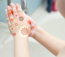 A child washes his hands with soap in the bathroom. The concept of hygiene and clean hands, infection, close-up, soundness