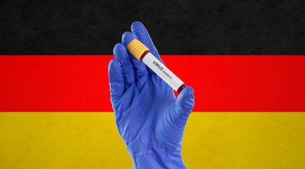 medicine, healthcare and pandemic concept - close up of hand in protective medical glove holding...