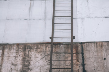 Iron staircase on a concrete wall
