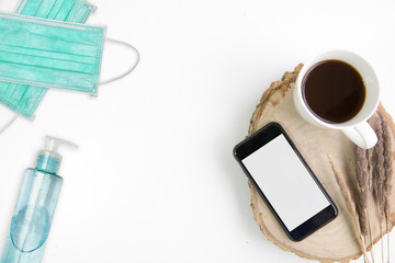 work from home desk table smart phone on top overhead with coffee cup in holiday weekend use gadget play social media looking product market for sale isolated at home in disease virus covid-19 scourge