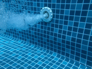 Air bubbles from jacuzzi jet in thermal spa swimming pool