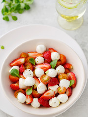 Salad with mozzarella, strawberries and cherry tomatoes. Healthy eating Vegetarian salad