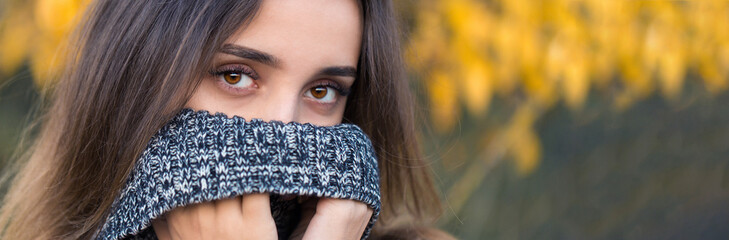 Autumn portrait of a girl in ethnic sweater