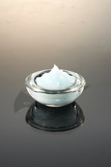 the texture of a cosmetic cream in a glass container.