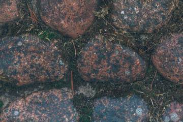 Antique masonry made of round granite stones from the Second World War