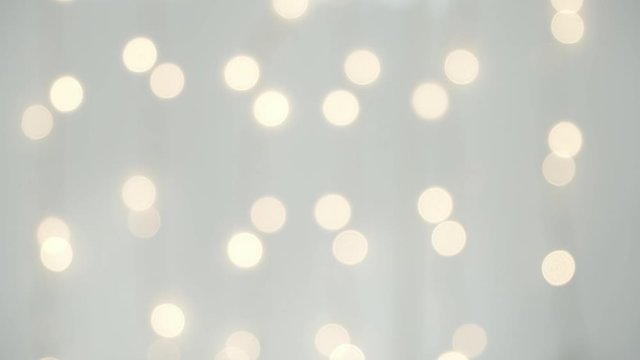 Abstract blurred sparkling light of golden garland. Christmas and New Year bokeh background. Fast and slow flickering of large lights