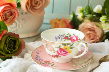 Vintage teacup, frame of pastel roses flowers