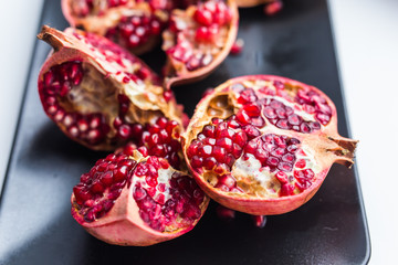 Big ripe red garnet. Fruits of red ripe pomegranate on the windows sill. Vegetarian, Organic vitamins, detox, diet concept. Organic and benefit garnet fruit.