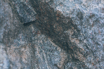 Wet stone. The wet surface of the rock. Background with mountain after rain closeup.
