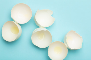 Egg and eggshell on a colored empty background. Minimal food concept, creative food.