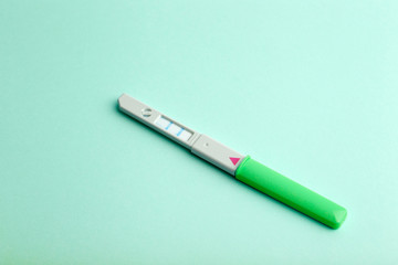 Pregnancy test on a blank colored background. Pregnancy, conception, and women's health. Birth of a baby concept