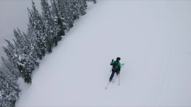 Splitboard Overhead Aerial of Man Climbing Uphill in Extreme Weather Conditions