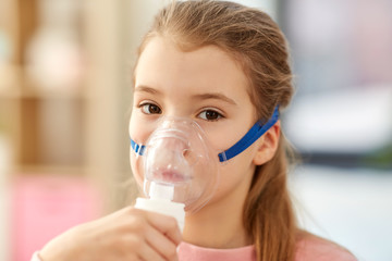 health, medical equipment and people concept - sick little girl wearing oxygen mask