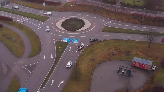 A bus exiting a round about in low traffic conditions.