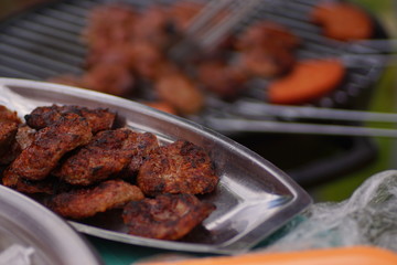 meatballs are cooking on the barbecue. cooking barbecue meat. man making barbecue meatballs. Enjoying a barbecue in the garden.