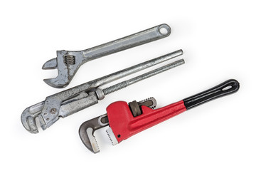 Different adjustable wrenches for plumbing work on a white background