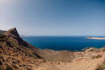 Fototapeta na wymiar Viewpoint with La Graciosa from Lanzarote. Panorama of scenic view of La Graciosa Island