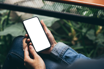 cell phone Mockup image blank white screen.woman hand holding texting using mobile on desk at coffee shop.background empty space for advertise.work people contact marketing business,technology