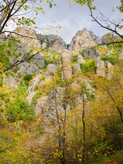 Weathered rocks through the branches of the autumn trees