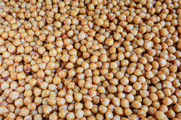 Marinated and cooked chickpeas with spices on an oven tray
