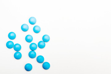 Blue pills on a white background. Space for text. Concept for medical news.