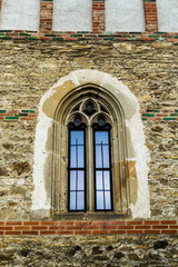 Fototapeta na wymiar Vintage window. Window in gothic style. Brick wall.