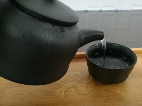 black tea pot on white background