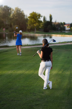 A Woman Throwing A Baseball On A Field