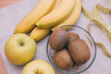 kiwi, apples, bananas on the table, proper and healthy food, fruit