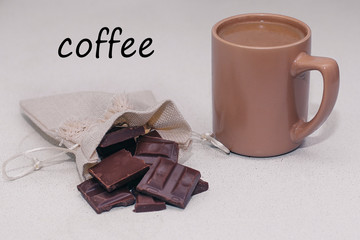 Coffee mug with milk and chocolate on the table for Breakfast
