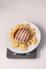 pork steak with macaroni on a plate for lunch, healthy food