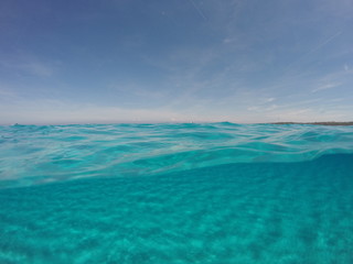 Fototapeta na wymiar Amazing blue sea with white sand underwater in Sardinia, Stintino, panorama background, ripple water surface with copy space