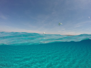 Amazing blue sea with white sand underwater in Sardinia, Stintino, seagulls, panorama background, ripple water surface with copy space