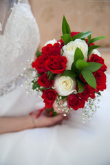 a bouquet of flowers in the hands of a girl for a wedding
