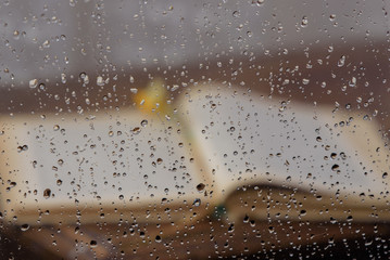 Drops of water on the transparent layer, blurred against the background of an open book