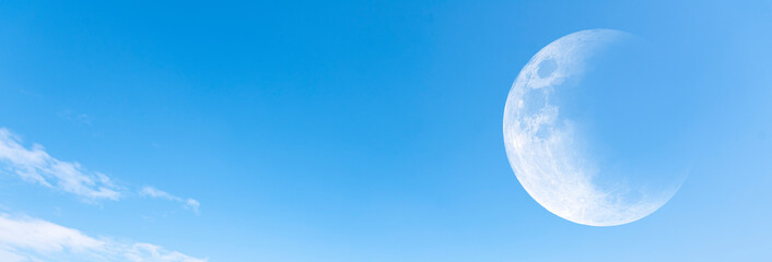 Moon and clear blue sky as background, panoramic view