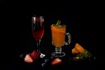 ren and orange alcohol beverages served in beautiful glasses