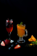 ren and orange alcohol beverages served in beautiful glasses