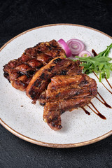 Closeup of pork ribs grilled on white plate