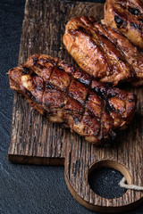 Closeup of pork ribs grilled on cutting board
