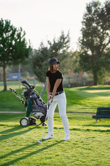 Woman playing golf on beautiful golf course