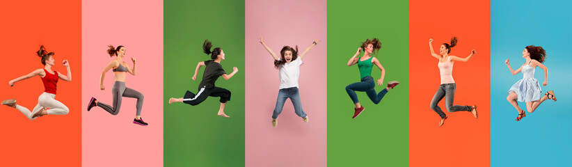 Young emotional people jumping high, look happy and cheerful on multicolored background....