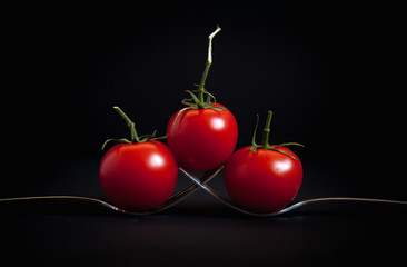 cherry tomatoes on black background