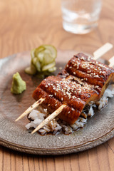 Unagi eel with rice on table