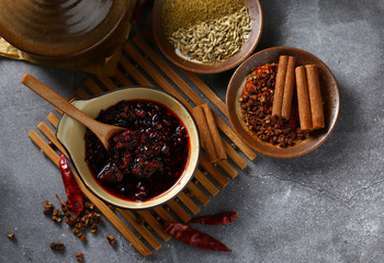 chili sauce in brown bowl on bamboo
