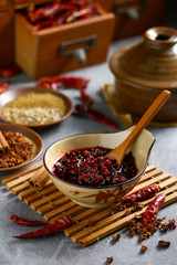 chili sauce in brown bowl on bamboo